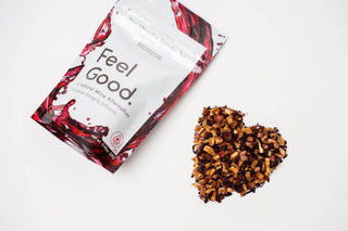 Packaged product labeled 'Feel Good' with a heart-shaped pile of nuts on a white background